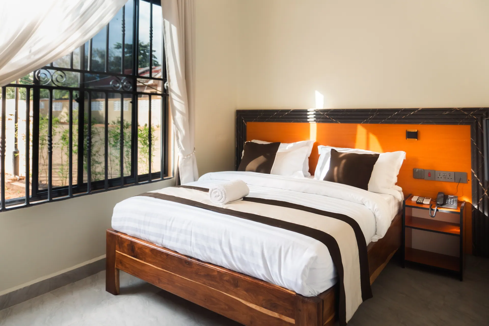 Bright MAWIO guest room with a wooden bed